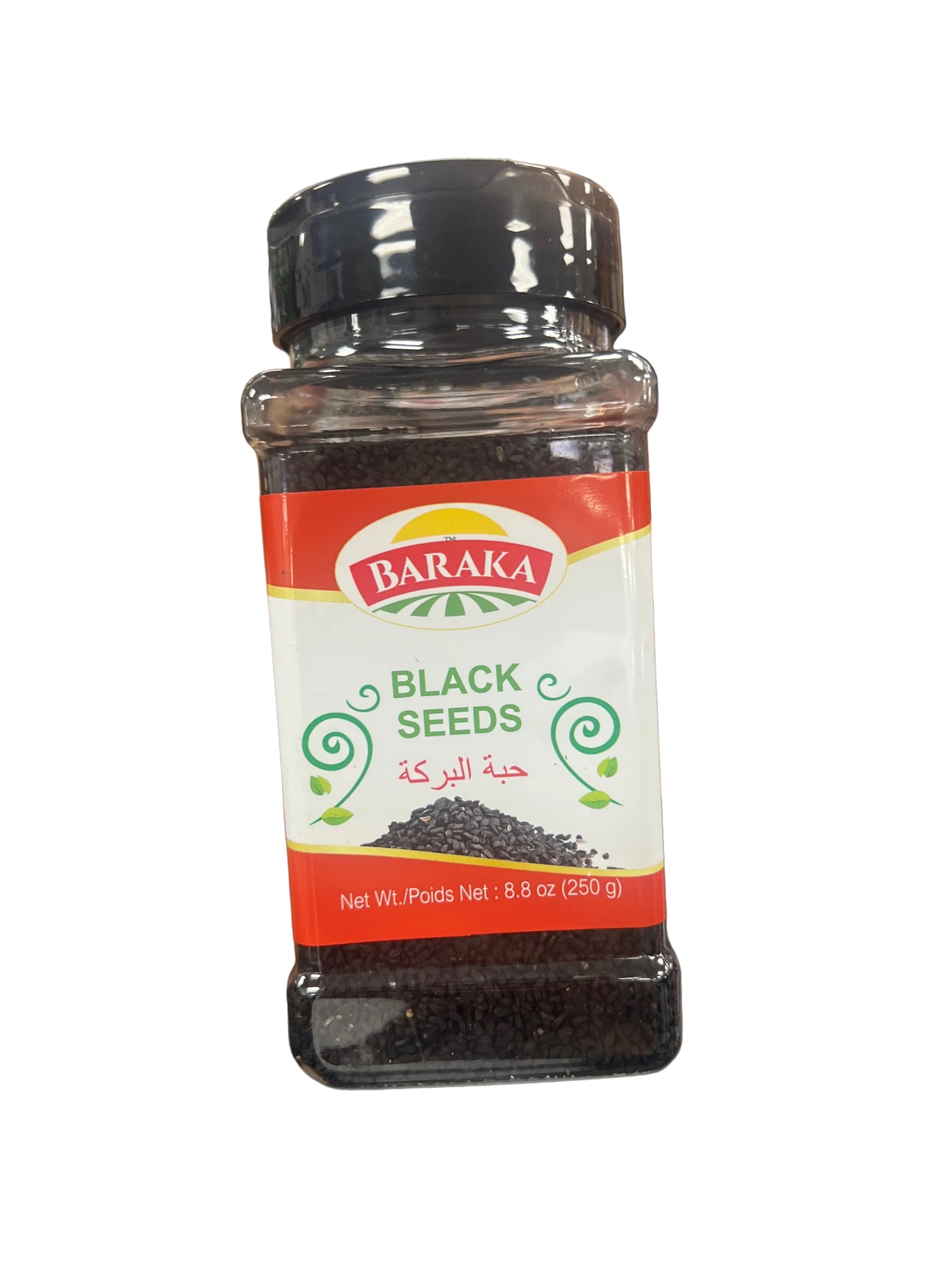 Bottle of Baraka Black Seeds held by a person with a blurred store background