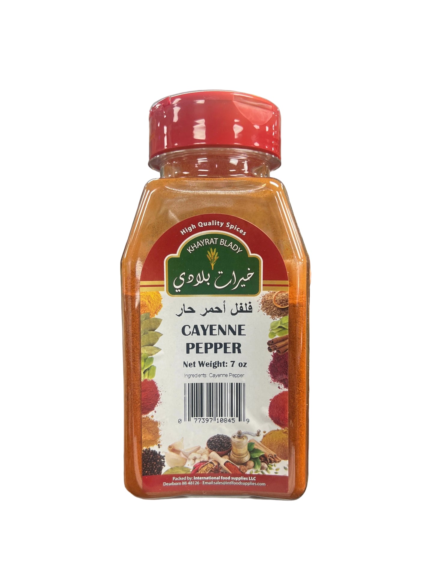 Hand holding a bottle of cayenne pepper with a blurred store background