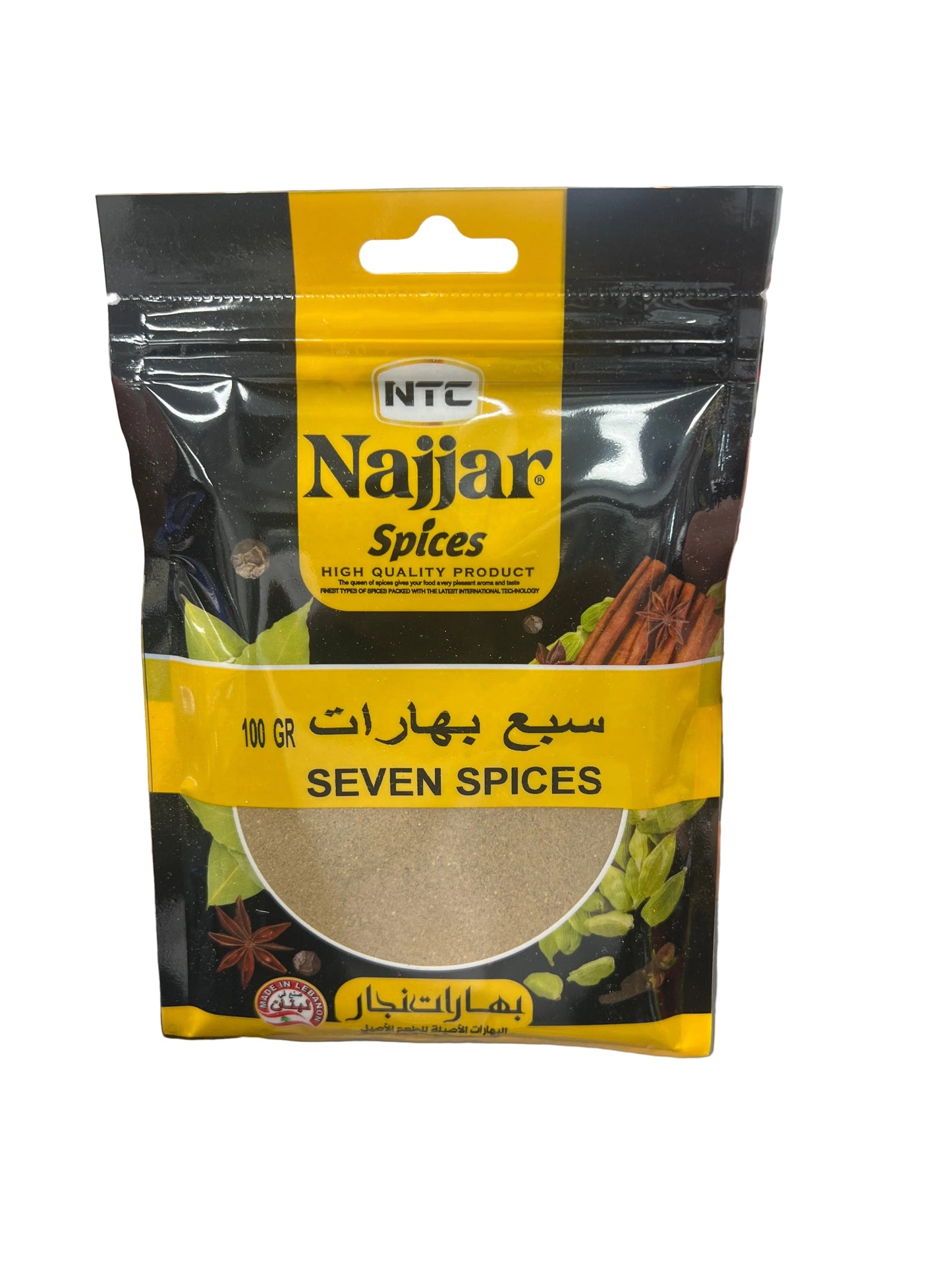 Hand holding a packet of Najjar Spices Seven Spices in a grocery store setting