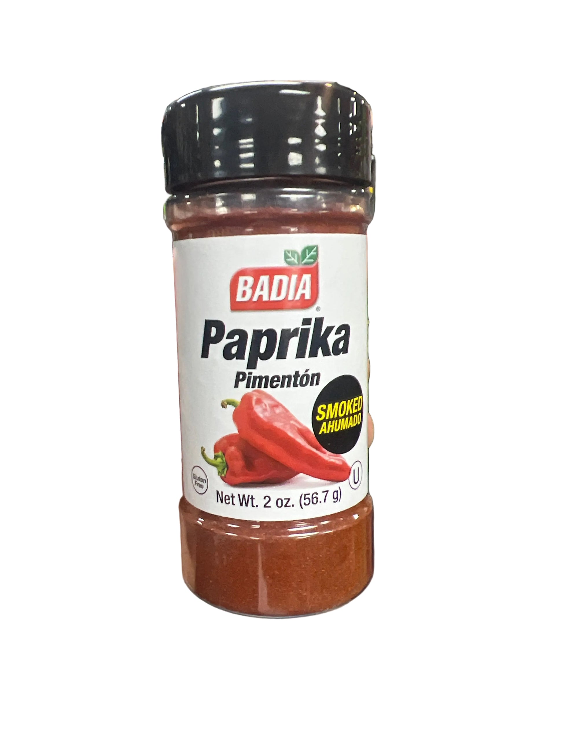 Hand holding a jar of Badia Paprika in a grocery store aisle.