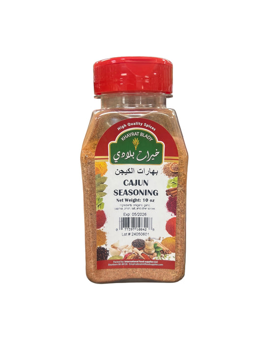 Hand holding a jar of seasoning with a blurred store aisle in the background