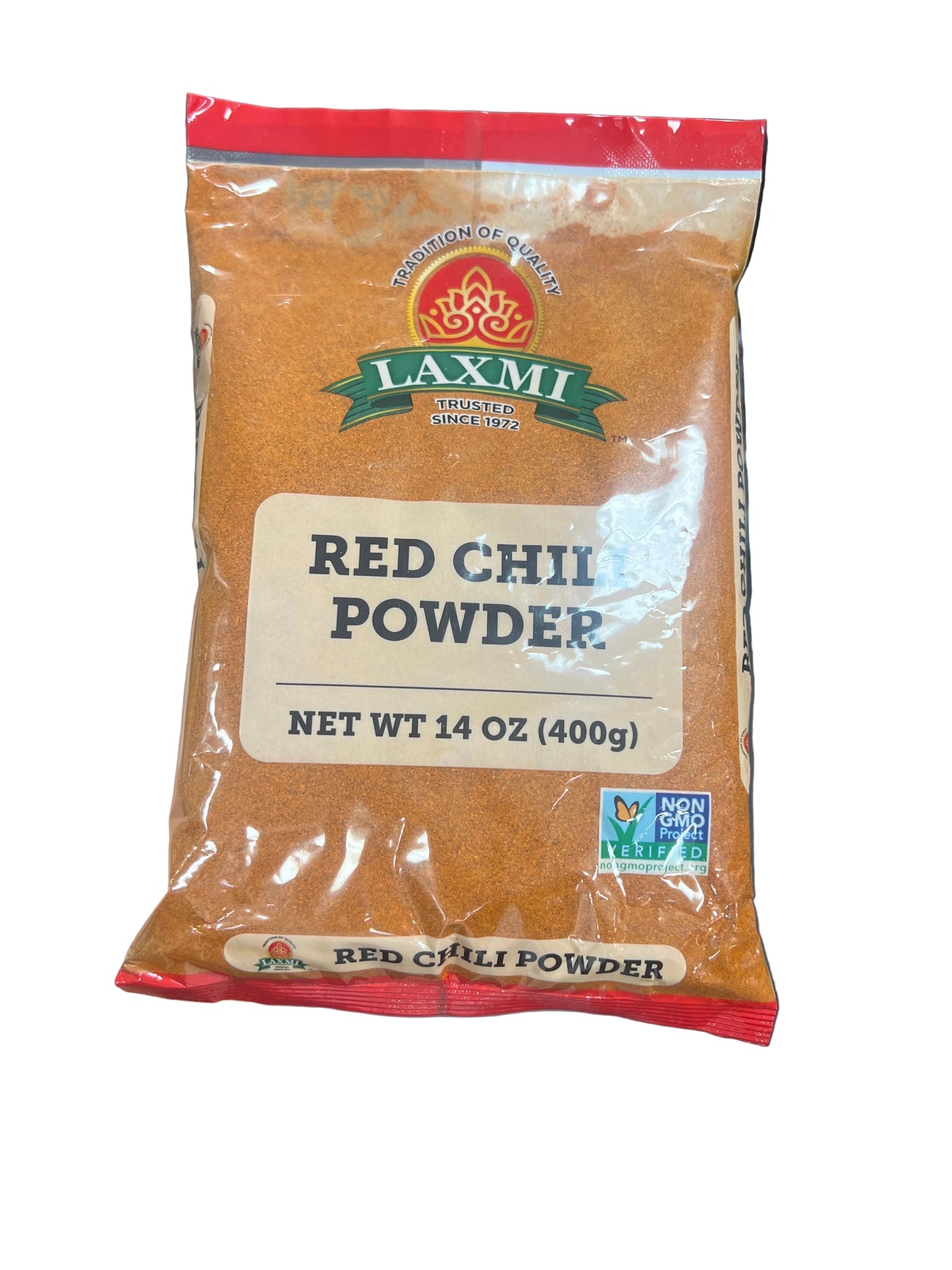 Pack of Laxmi Red Chilipowder held in a hand with a blurred store background