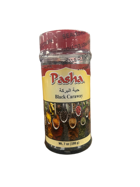 Hand holding a jar of Pasha Black Caraway in a grocery store aisle.
