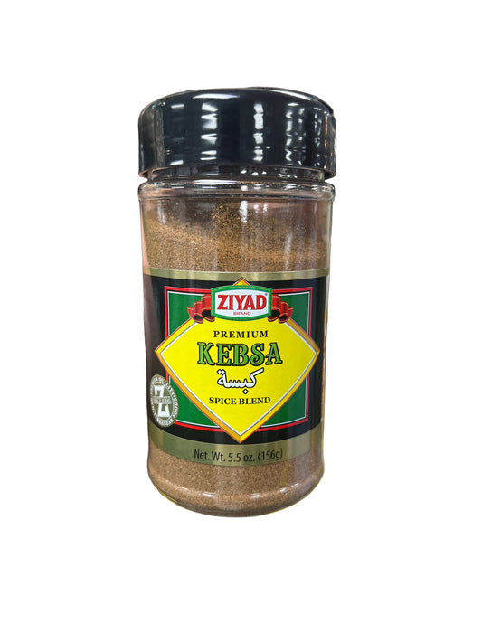 Hand holding a bottle of Kevska spice blend with a supermarket background